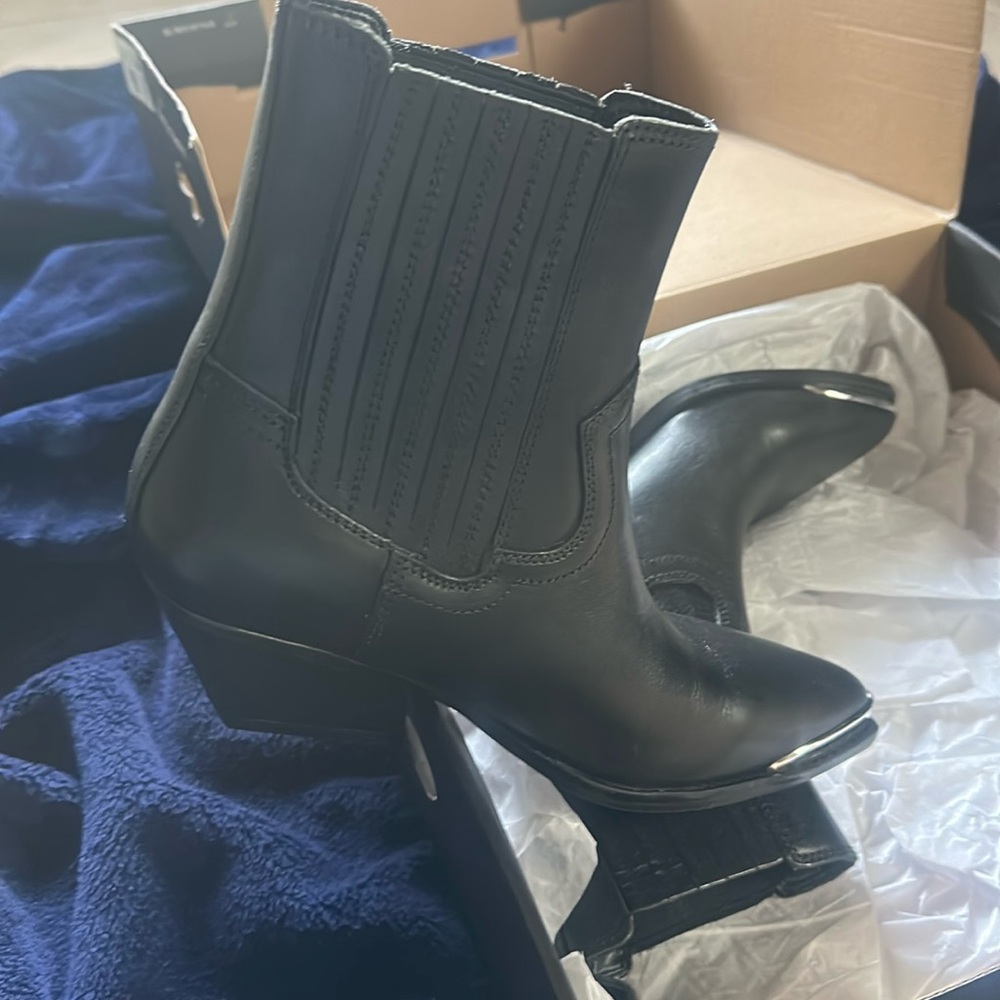 The Marc Fisher Ltd. Pryce Booties feature a pointed toe and a block heel.